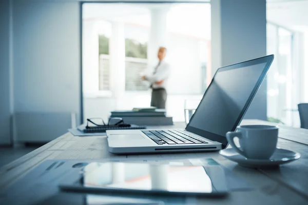 depositphotos_78294064-stock-photo-executive-standing-in-his-office